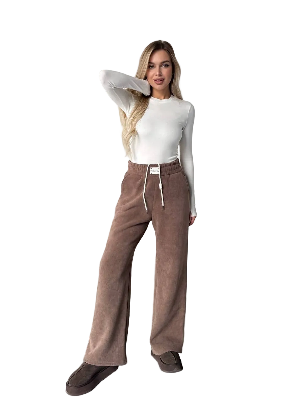 Woman wearing brown pants and a white top on a white background