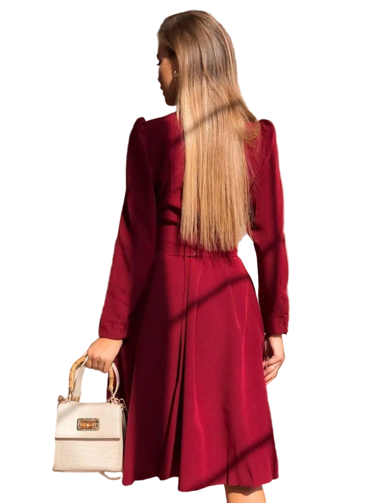 Woman wearing a red coat holding a beige handbag on a white background