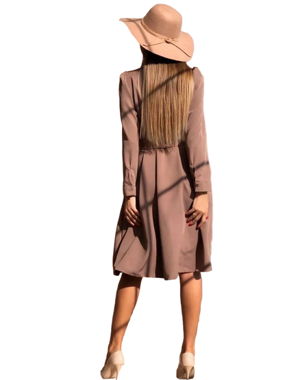 Person wearing a long-sleeve dress and wide-brimmed hat on a white background