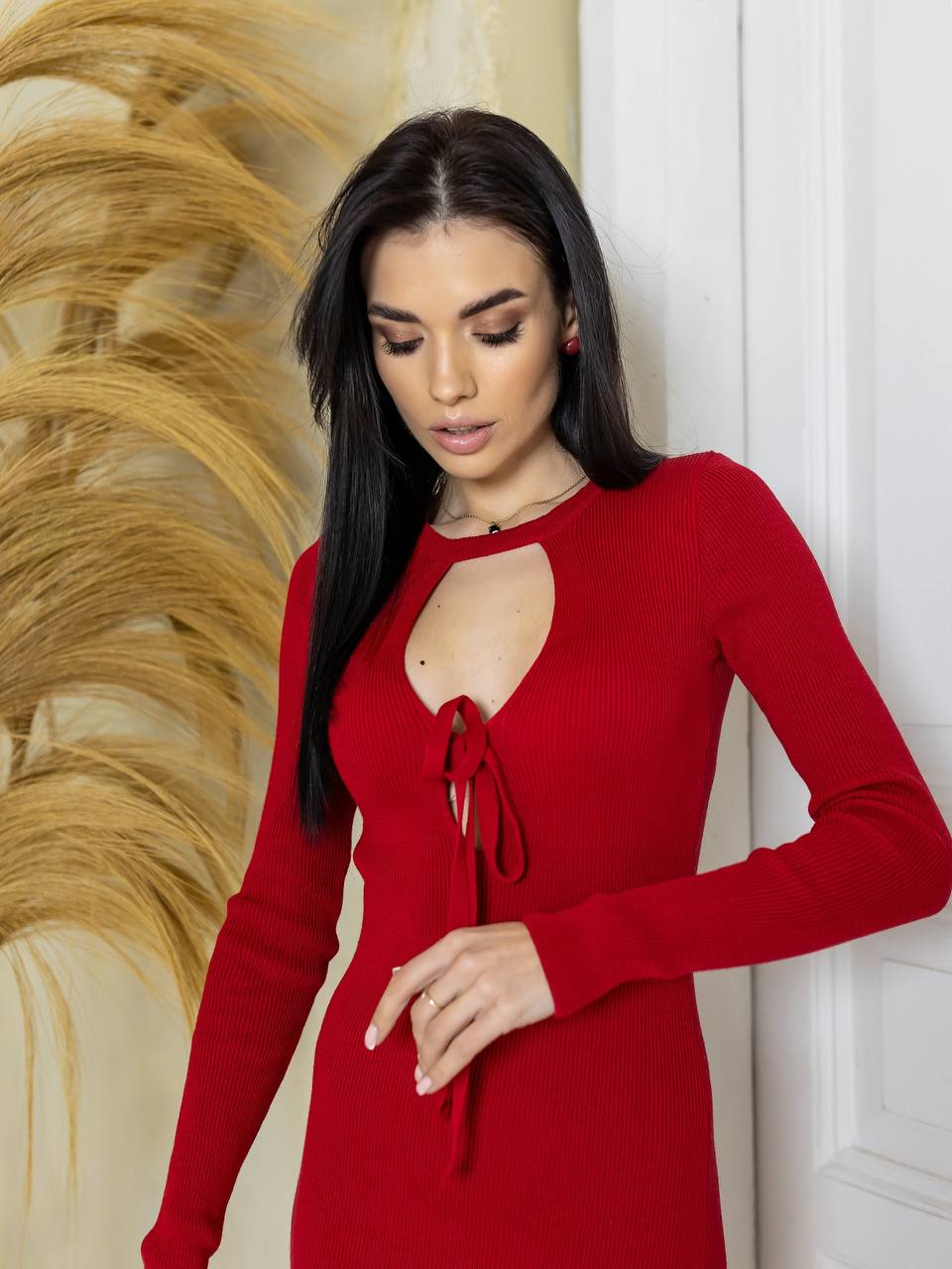 Woman wearing a red dress with a decorative background