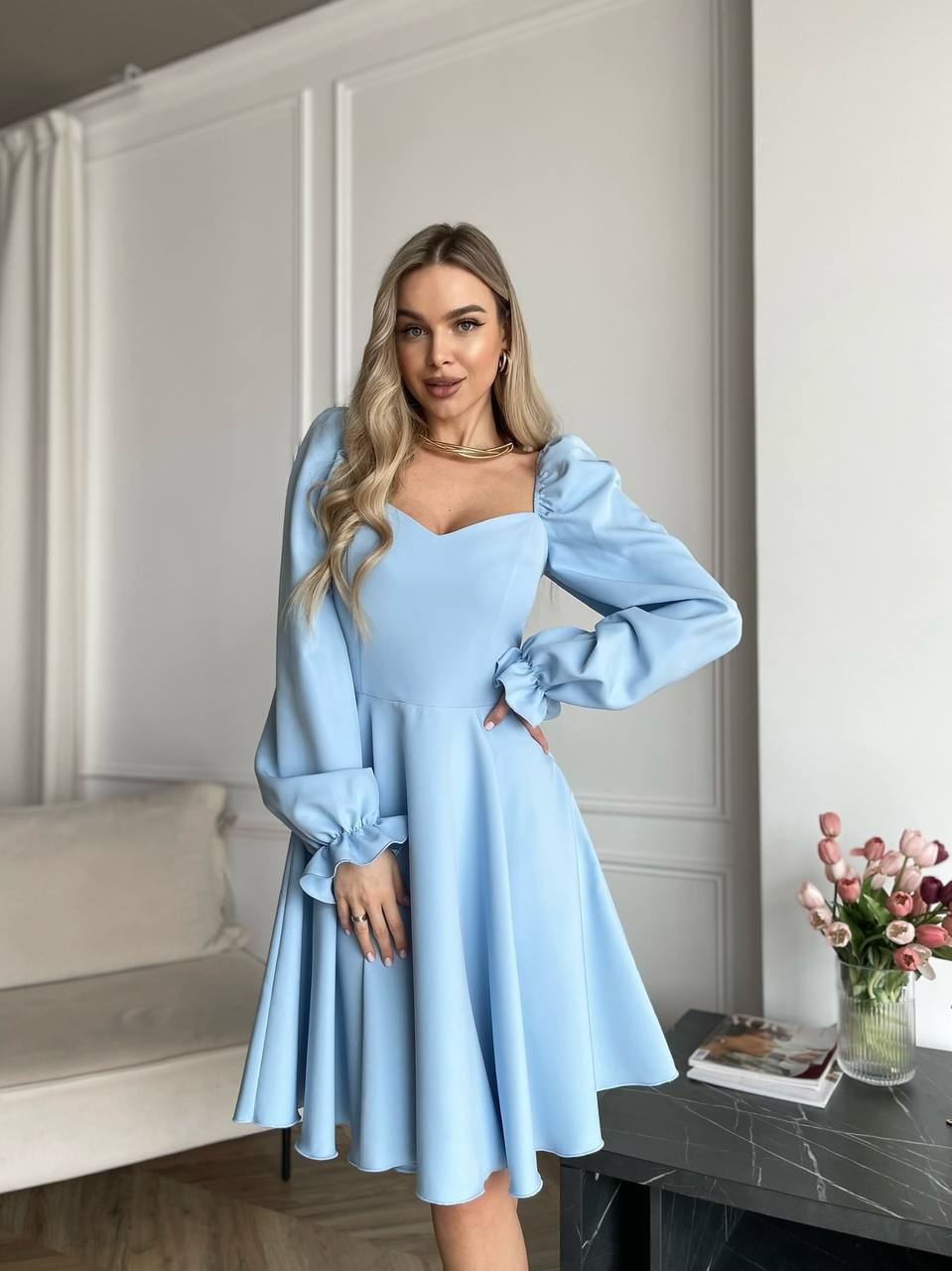 Woman wearing a light blue dress in an indoor setting