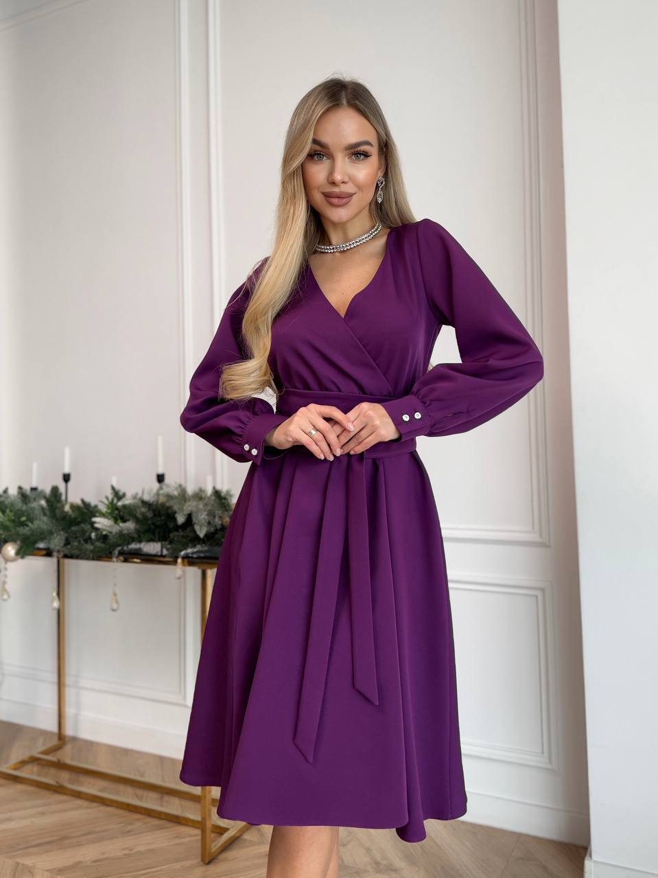 Woman wearing a purple dress in an indoor setting