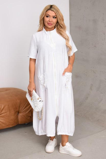 Woman wearing a white outfit with a plain background