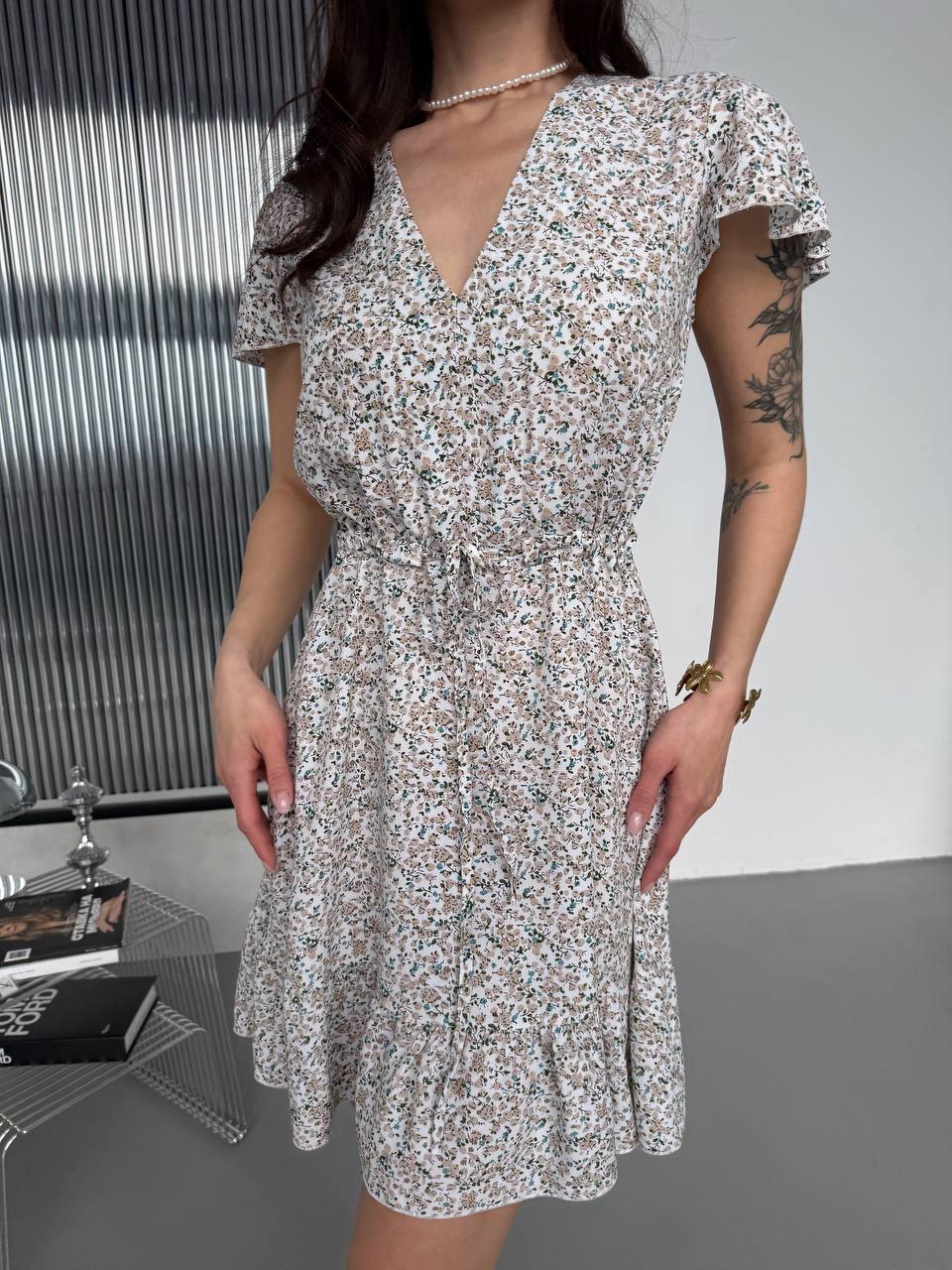 Woman wearing a floral dress with a minimal background