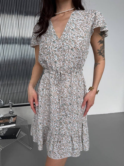 Woman wearing a floral dress with a minimal background