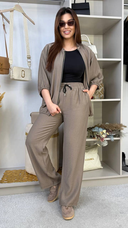 Woman wearing a beige outfit with sunglasses in a store setting