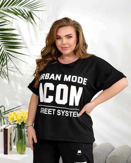 Woman wearing a black t-shirt with white text in a casual setting