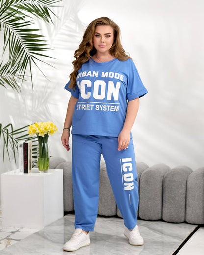 Woman wearing a blue 'ICON' branded outfit in a living room setting.