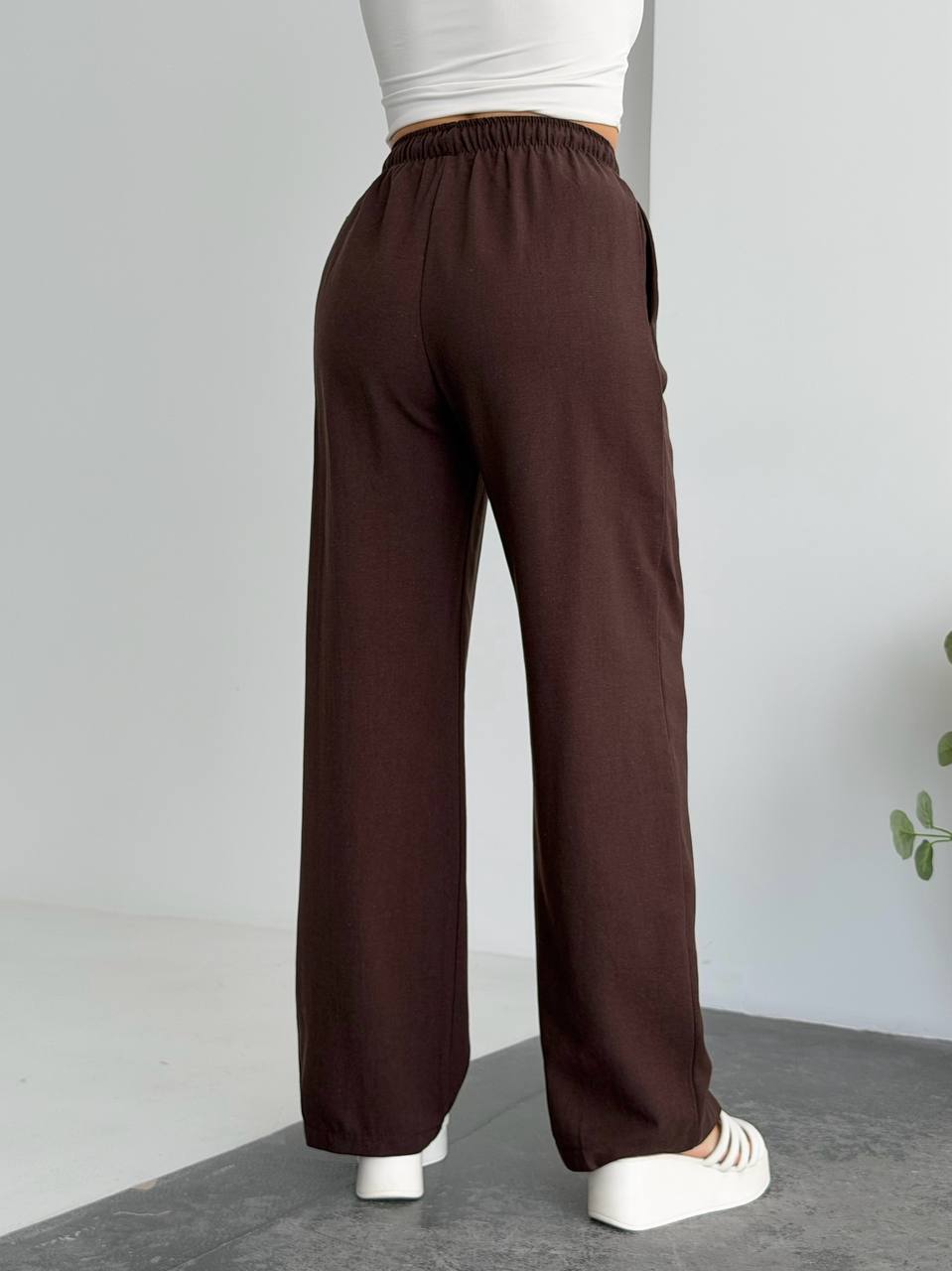 Brown wide-leg pants worn by a person on a plain background