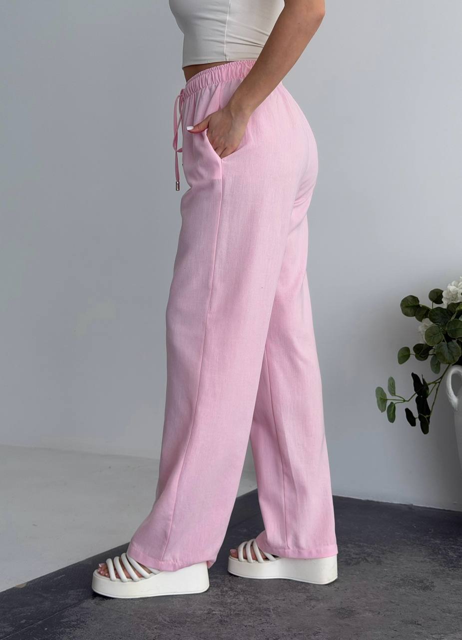 Person wearing pink pants with a white background