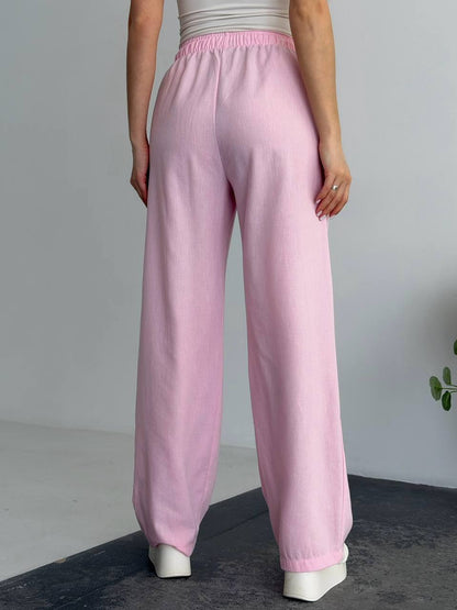 Person wearing pink pants on a plain background