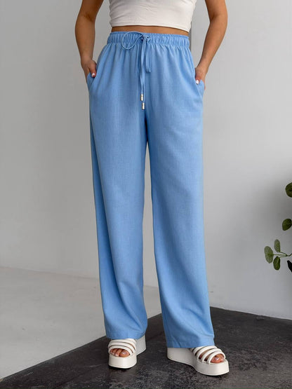 Person wearing blue pants with a white background