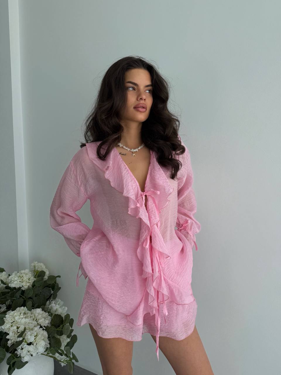 Woman wearing a pink outfit with a white background
