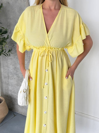 Woman wearing a yellow dress with a white background