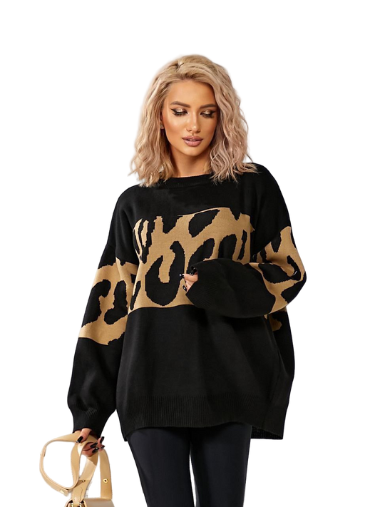Woman wearing a black sweater with a gold leopard print pattern on a white background