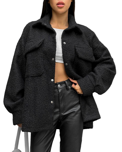 Person wearing a black oversized jacket with a white background