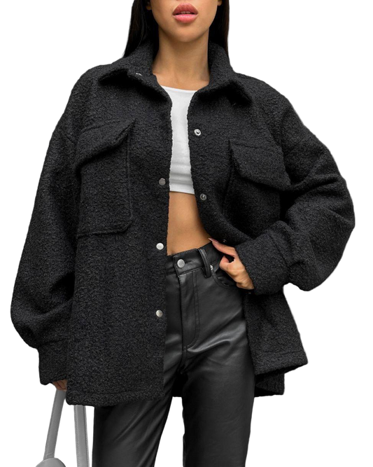 Person wearing a black oversized jacket with a white background