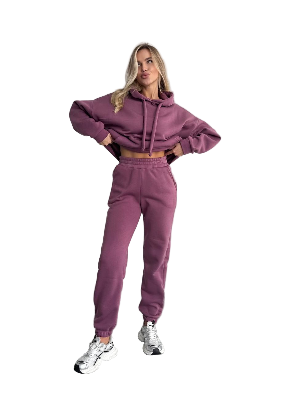 Woman wearing a purple tracksuit on a white background