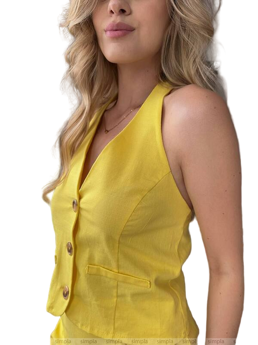 Yellow sleeveless top worn by a person on a white background