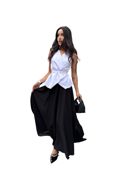 Woman wearing a white top and black skirt with a handbag on a white background