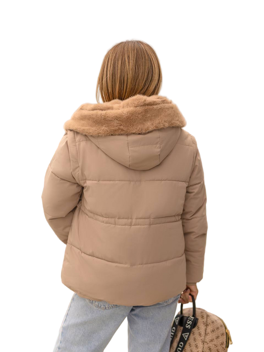 Person wearing a beige puffer jacket with fur hood on a white background