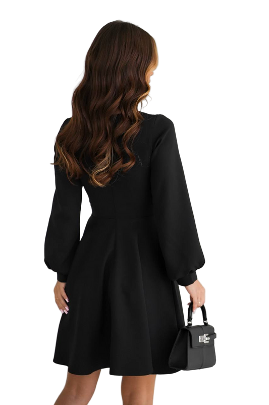 Woman wearing a black dress holding a black handbag on a white background
