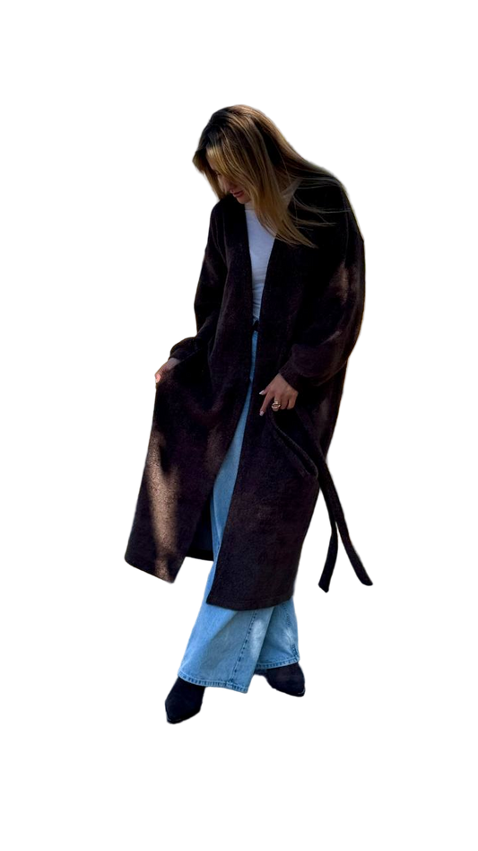 Person wearing a long brown coat on a white background