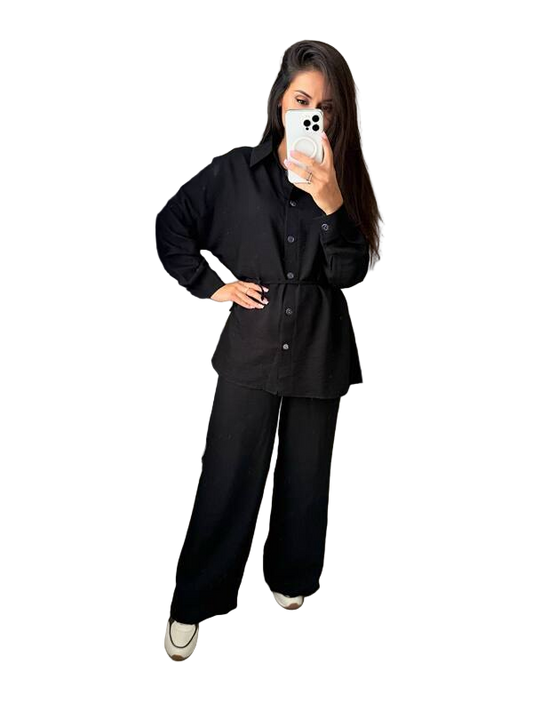 Person wearing a black outfit with a white background