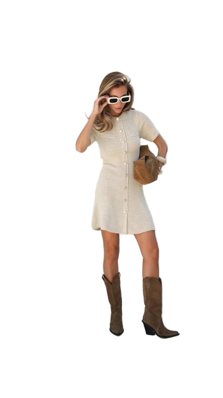 Woman in a cream dress with brown boots and sunglasses on a white background