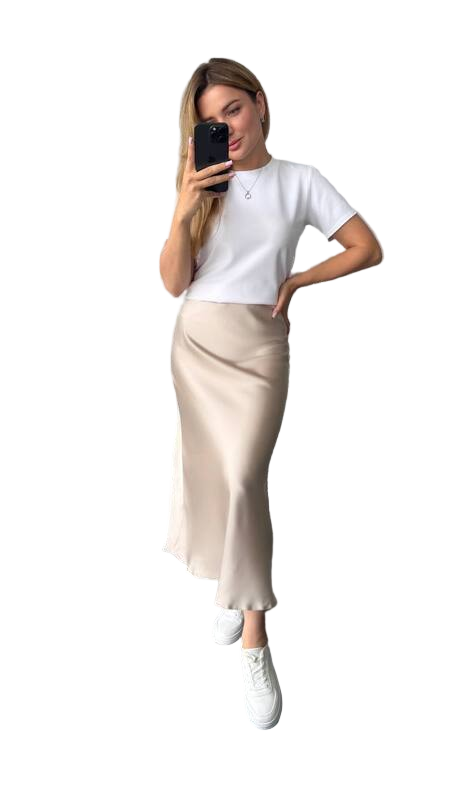 Person wearing a white t-shirt and beige skirt on a white background