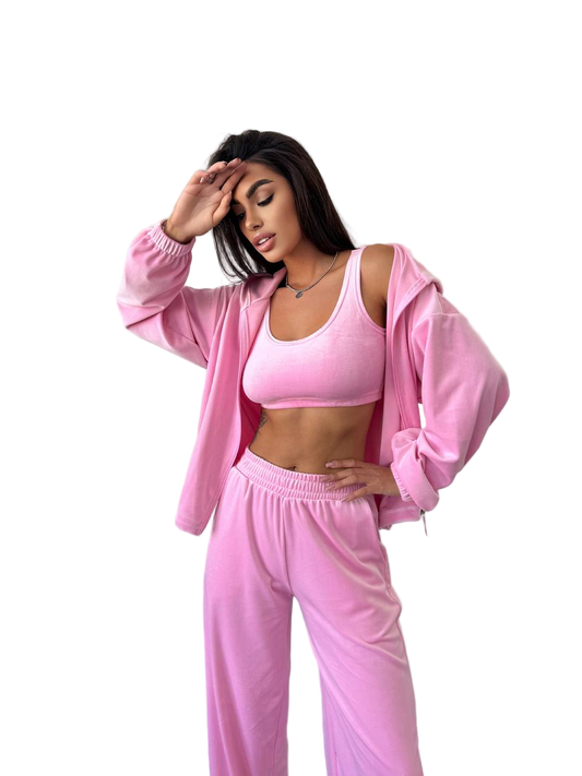 Woman wearing a pink tracksuit on a white background