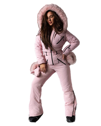 Person wearing a pink snowsuit with fur trim on a white background
