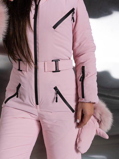 Person wearing a pink snowsuit with black zippers and fur accents.