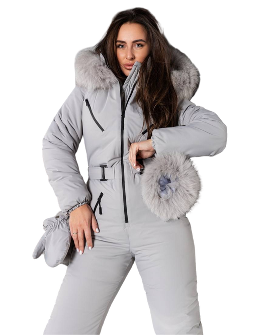 Woman wearing a gray snowsuit with fur trim on a white background