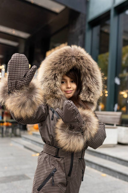 Person wearing a fur-lined coat with a hood in an urban setting
