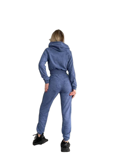 Person wearing a blue tracksuit on a white background