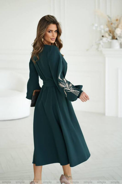 Woman wearing a dark green dress with a white background