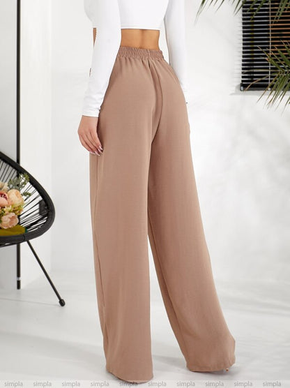 Beige wide-leg pants worn by a person on a white background