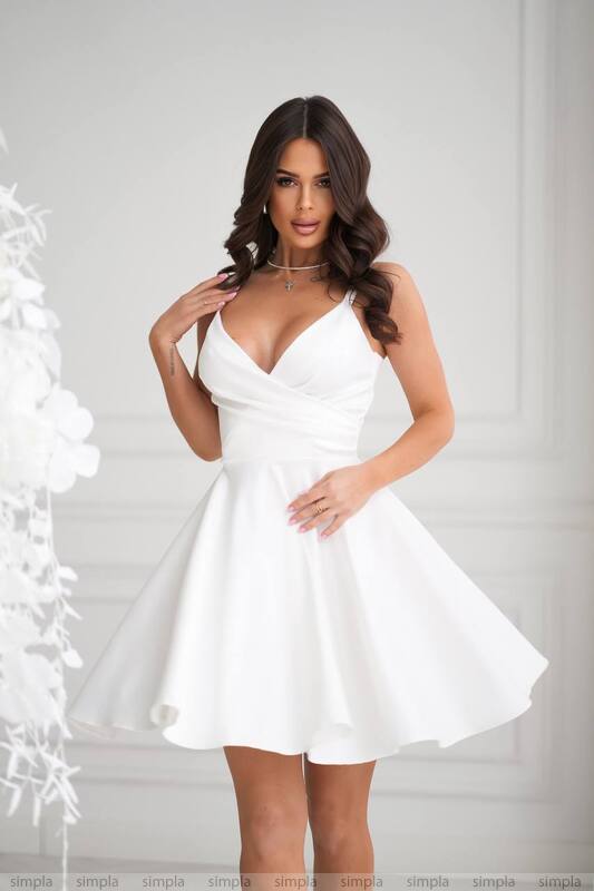 Woman wearing a white dress against a white background