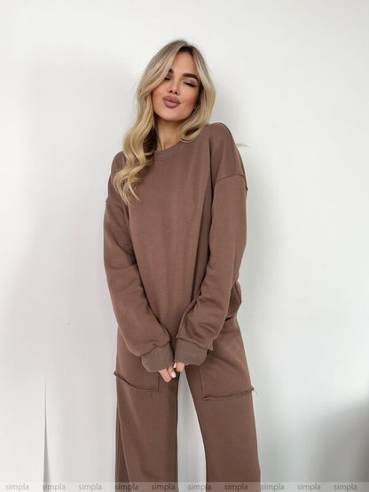 Woman wearing a brown outfit against a white background