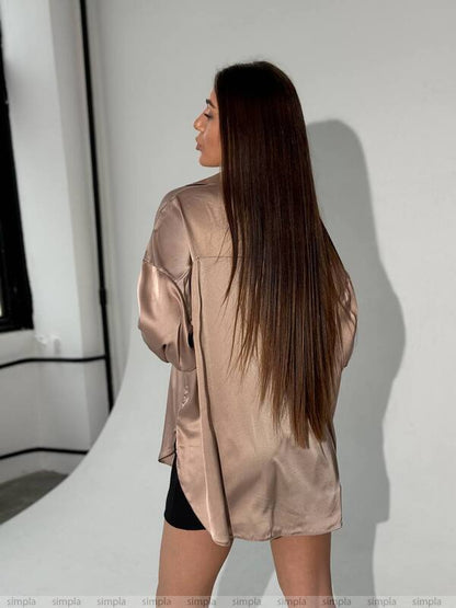 Woman wearing a satin robe and shorts in a minimalistic setting