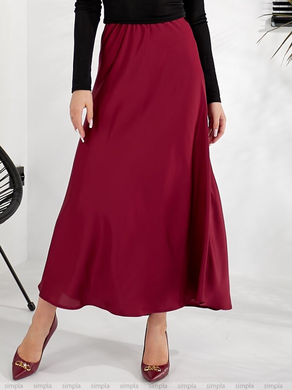 Maroon skirt worn by a person on a white background