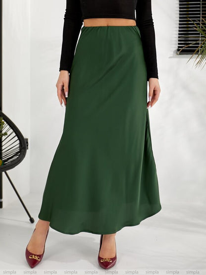 Green skirt worn by a person on a white background