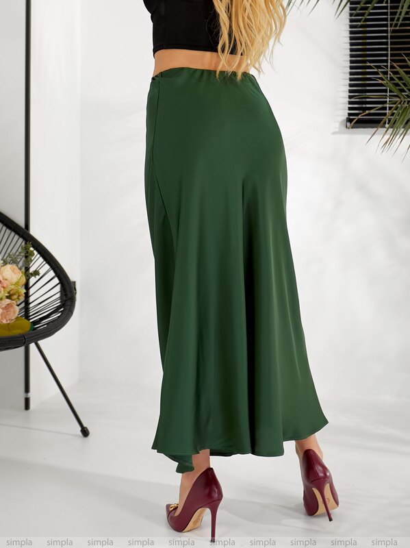 Green skirt worn by a person on a white background