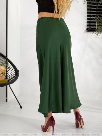 Green skirt worn by a person on a white background