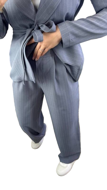 Person wearing a gray pinstripe suit with a white background