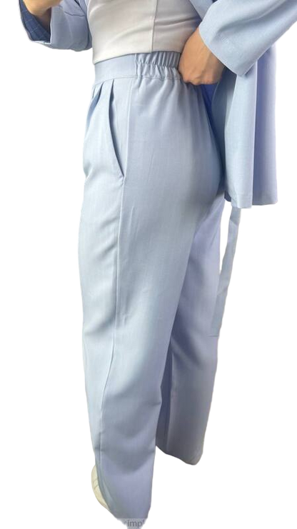 Person wearing a light blue outfit with a white background