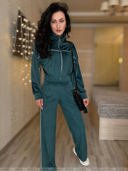 Woman wearing a teal tracksuit in an indoor setting