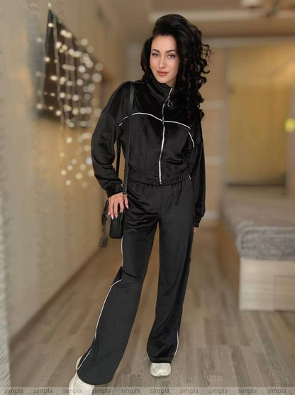 Woman wearing a black tracksuit in an indoor setting