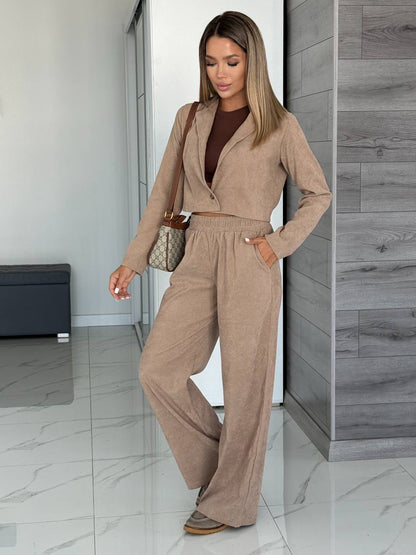 Woman wearing a beige outfit in an indoor setting